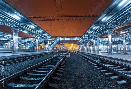 Railway station at night. Train platform in fog. Railroad