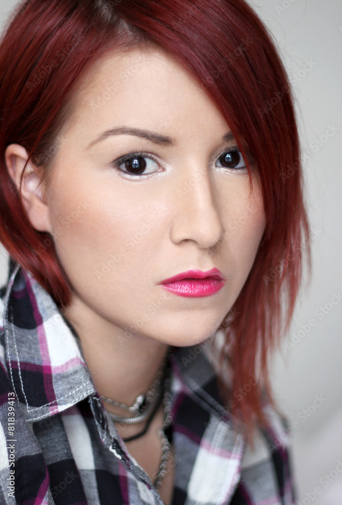 Redhead young woman in plaid shirt portrait Redhead young woman in plaid shirt portrait