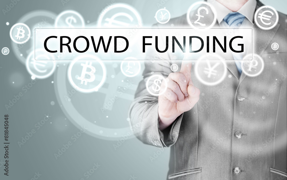 Businessman pushes virtual crowd funding button Businessman pushes virtual crowd funding button
