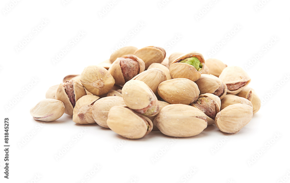 Heap of pistachios nuts isolated on the white Heap of pistachios nuts isolated on the white