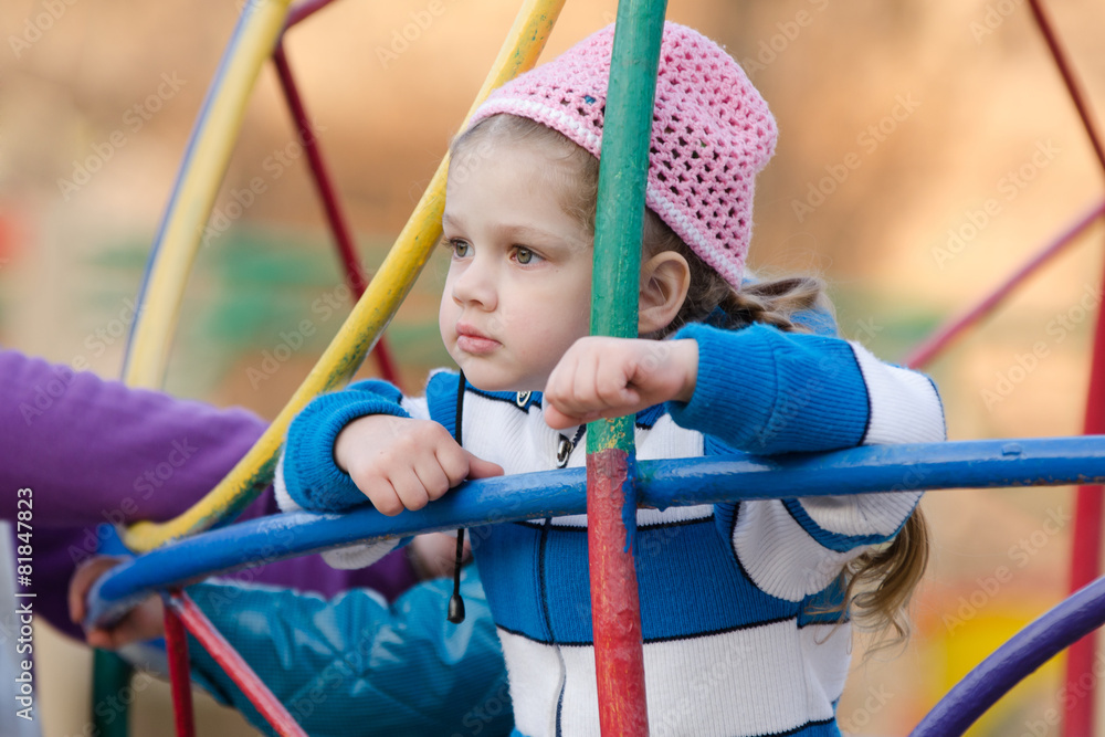 Four-year girl thought playing on the playground Four-year girl thought playing on the playground