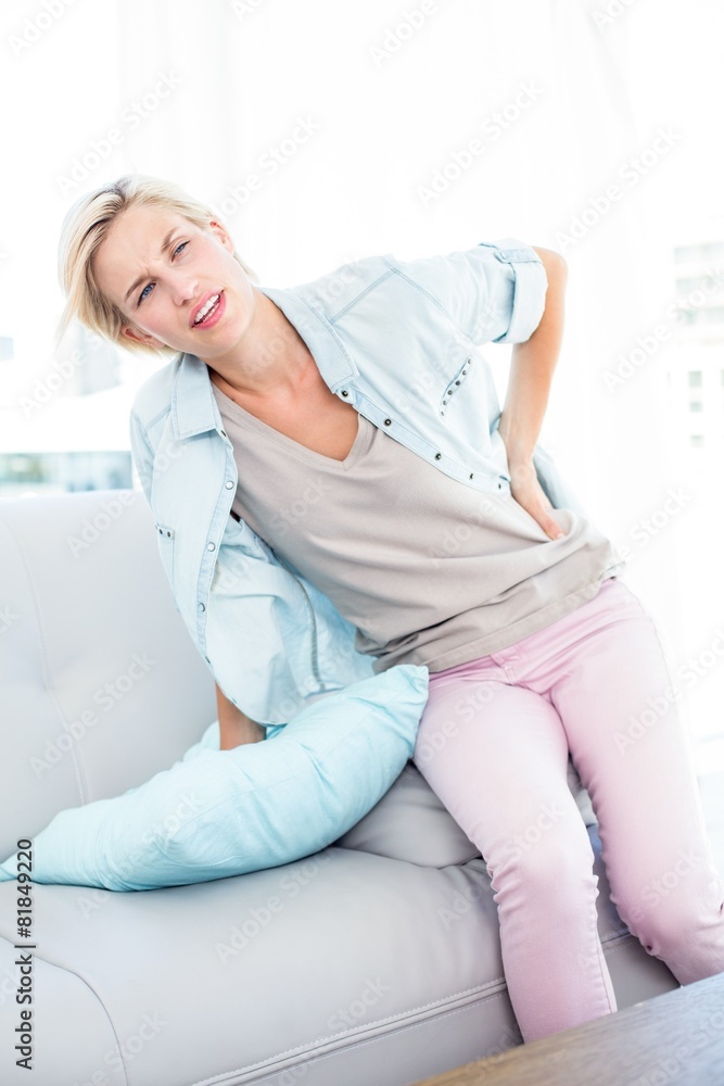 Blonde woman having backache Blonde woman having backache