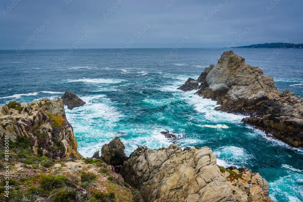 Large rocks and waves in the Pacific Ocean, seen from a beach at