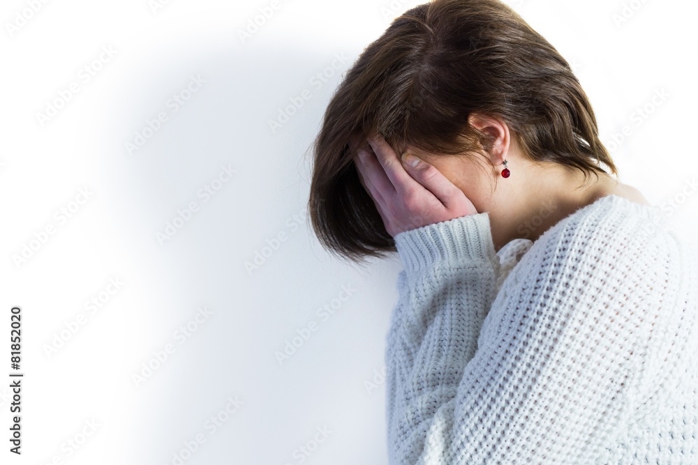 Sad pretty brunette crying with head on hands Sad pretty brunette crying with head on hands