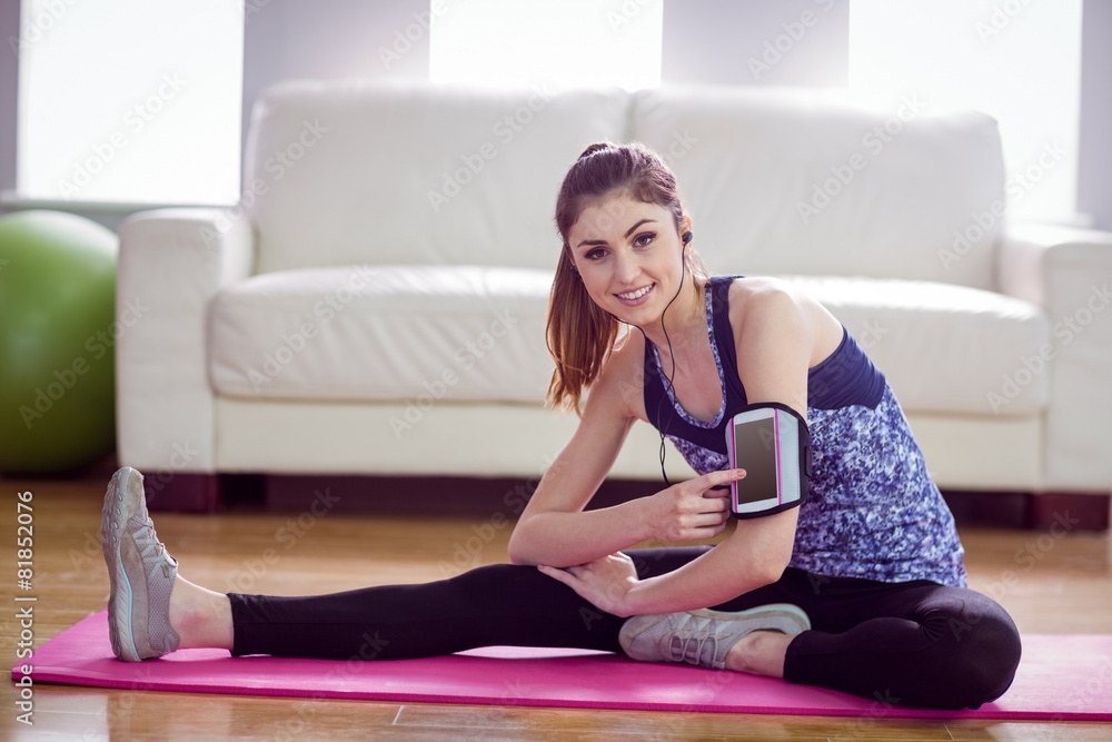 Fit woman stretching on exercise mat Fit woman stretching on exercise mat