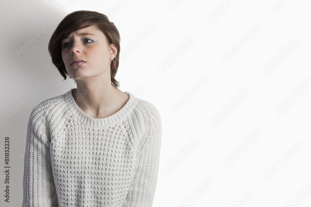 Sad pretty brunette leaning against wall Sad pretty brunette leaning against wall