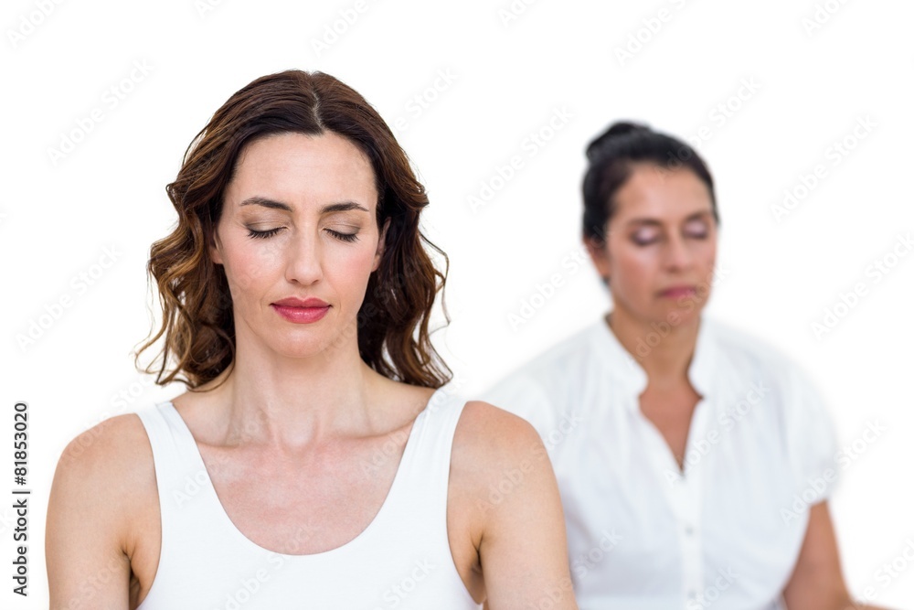 Women sitting in lotus pose Women sitting in lotus pose