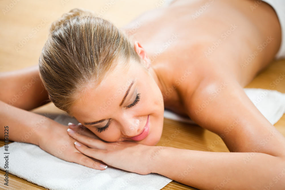 Young woman relaxing after massage on spa treatment Young woman relaxing after massage on spa treatment