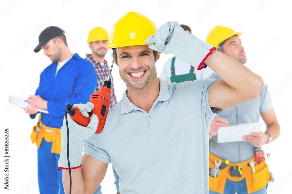 Composite image of handsome architect holding drill machine Composite image of handsome architect holding drill machine