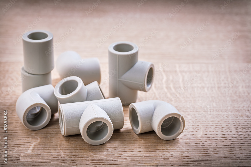 Set Of Polypropylene Pipe Fittings On Wooden Board Set Of Polypropylene Pipe Fittings On Wooden Board