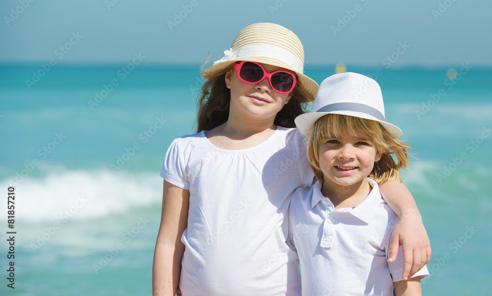 Brother and sister on the beach enjoying summer vacation Brother and sister on the beach enjoying summer vacation