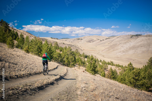 The girl on bicycle down a steep hill