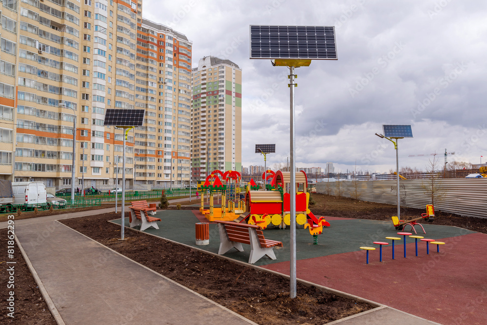 children's playground of an apartment house with solar panels children's playground of an apartment house with solar panels