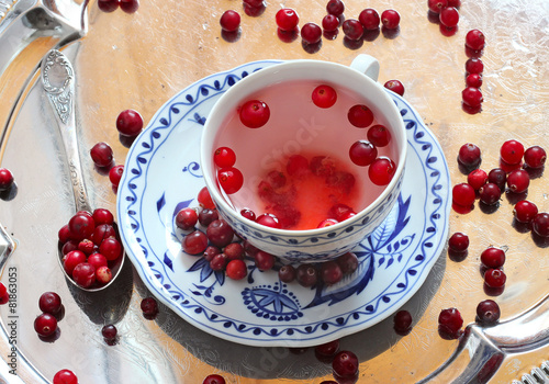 Cranberry tea and berries in saucer on a tray