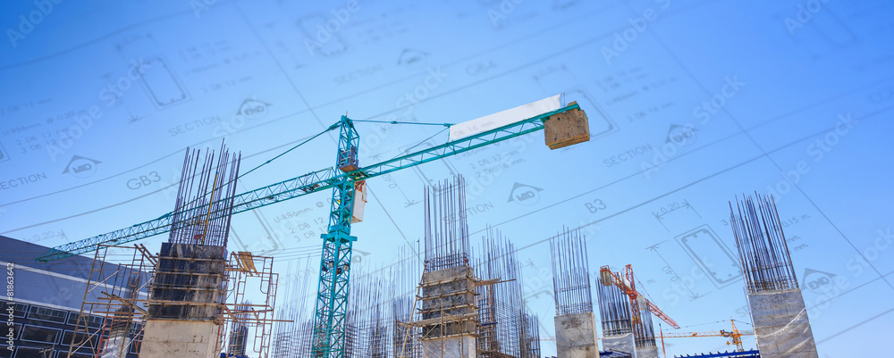 Building crane and construction site under blue sky