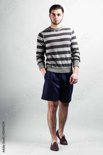 Man in casual style on gray background © Africa Studio