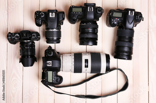 Принти на полотні Modern cameras on wooden table, top view