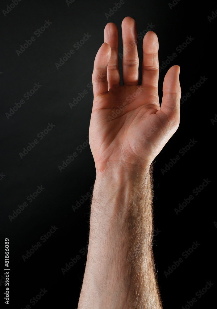 Male hand on dark background Male hand on dark background