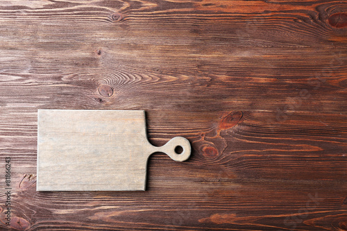 Cutting board on wooden background