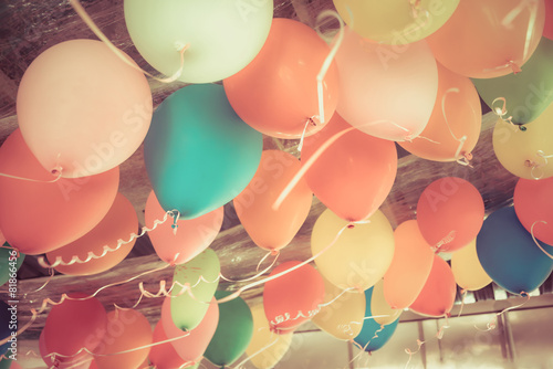 Colorful balloons floating on the ceiling of a party in vintage
