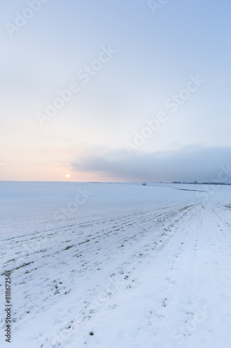 Agricultural field at the winter wind evening