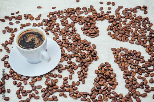 Cup of coffee and beans on beige background with human