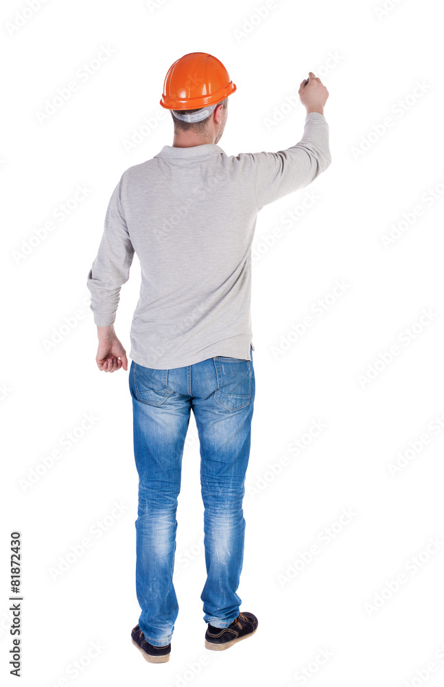 back view of writing engineer in construction helmet. back view of writing engineer in construction helmet.