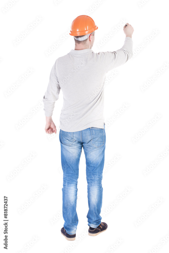 back view of writing engineer in construction helmet. back view of writing engineer in construction helmet.