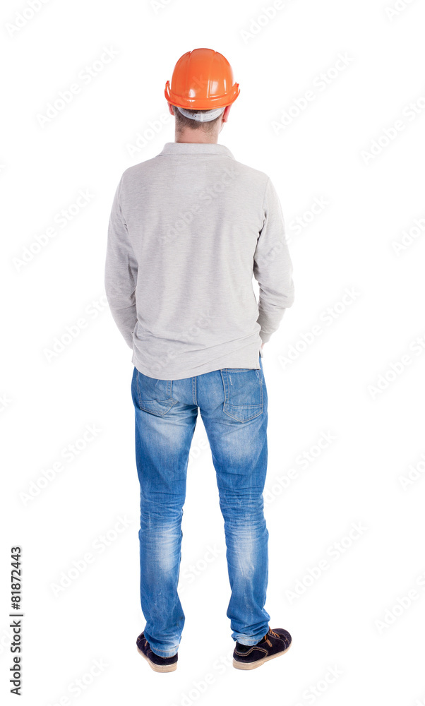 Backview of an engineer in construction helmet stands. Backview of an engineer in construction helmet stands.