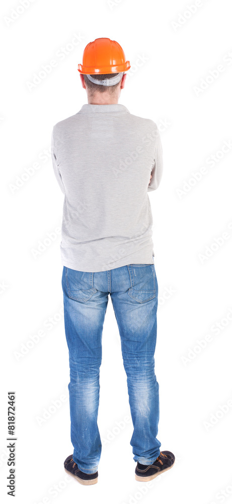 Backview of an engineer in construction helmet stands. Backview of an engineer in construction helmet stands.