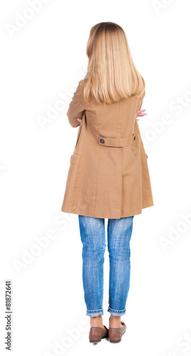 back view of standing young beautiful  blonde woman in brown clo © ghoststone