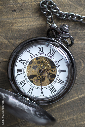 pocket watch on rustic wooden background