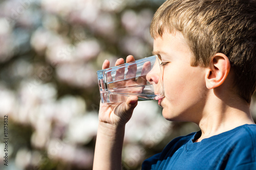 Boy drinking pure water from glass