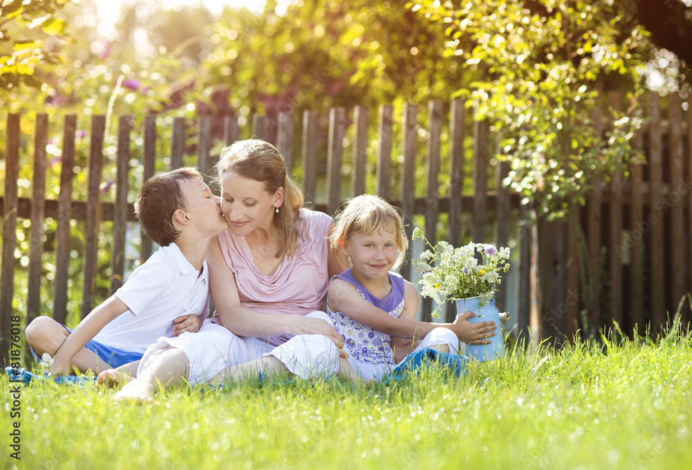 Happy mother with her children spending time together outside Happy mother with her children spending time together outside