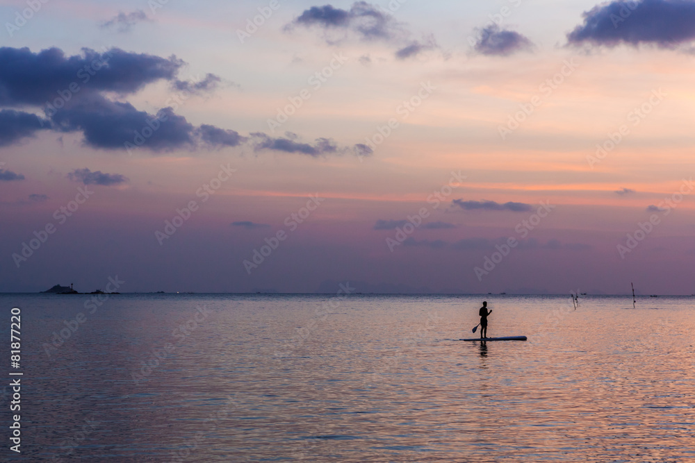 One man floating in water background beautiful sunset