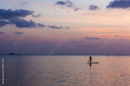 One man floating in water background beautiful sunset © Iryna&Maya