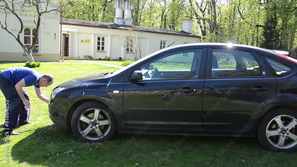 Panorama of young man clean wash black favorite car with foam Panorama of young man clean wash black favorite car with foam