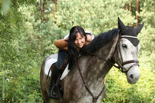 Beautiful woman and gray horse portrait in garden © virgonira