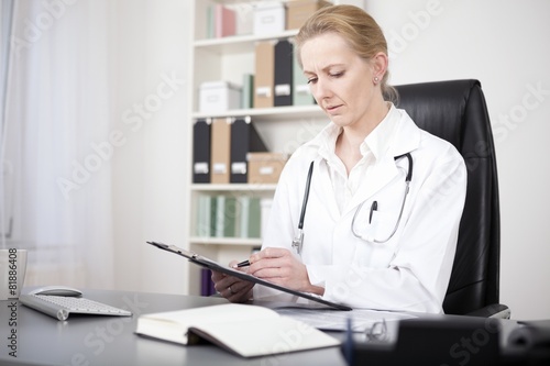 Serious Woman Doctor Reviewing Written Findings