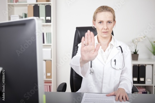 Serious Female Doctor Showing Stop Hand Pose