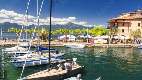High mountains and sailing boat on the Lake Garda, Italy