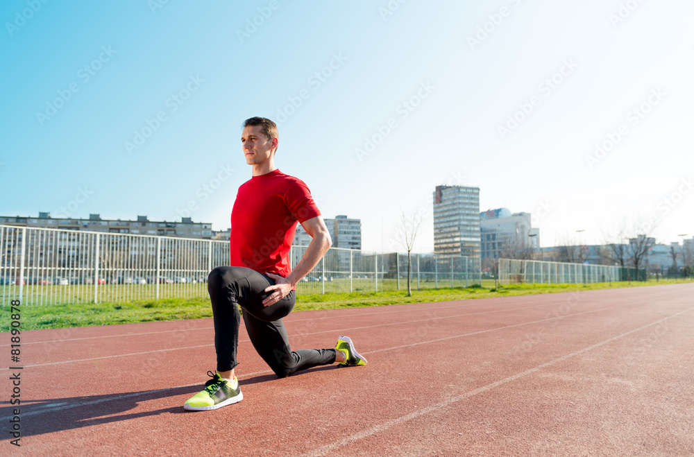 Fototapeta premium Athlete warming and stretching