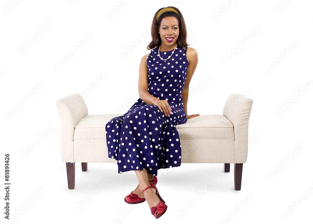 woman wearing a blue polka dot dress sitting on a chaise Stock Photo |  Adobe Stock