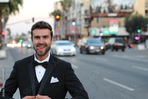 Elegant man in a tuxedo showing his tongue © ajr_images