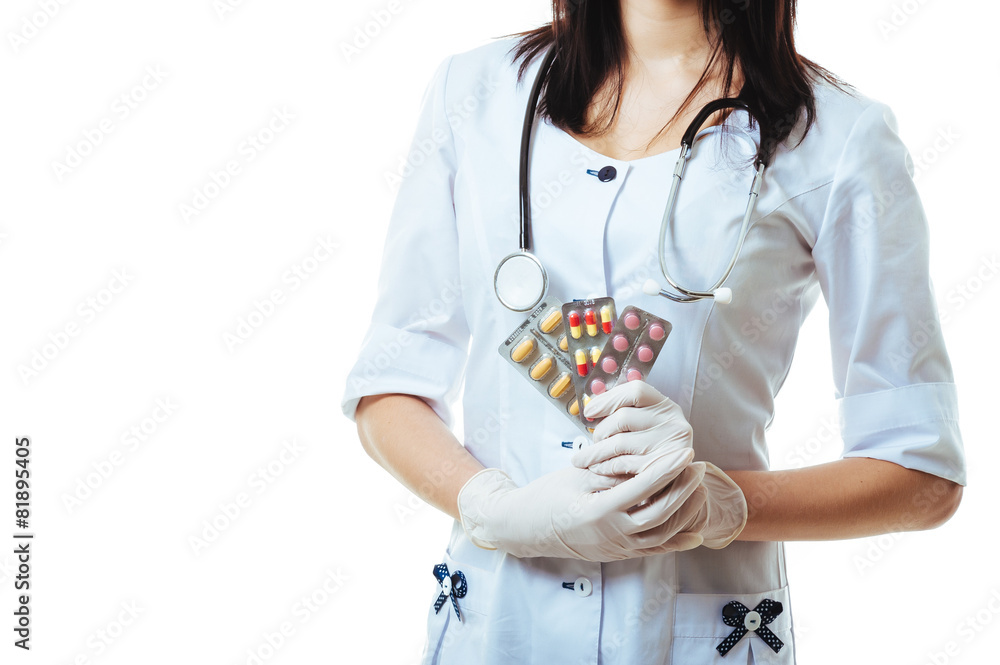 Young and friendly woman doctor holding offering pills isolated Young and friendly woman doctor holding offering pills isolated