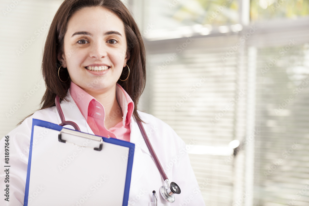 Portrait of a friendly female doctor holding a medical clipboard Portrait of a friendly female doctor holding a medical clipboard