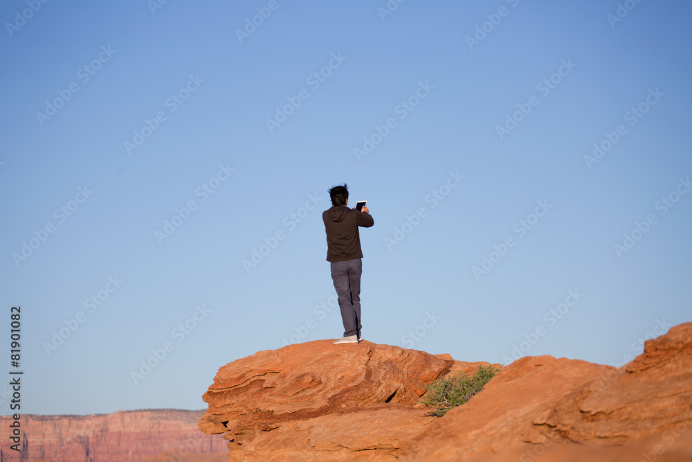 Man taking a photograph or a selfie, taking pictures, on a mount