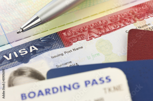 USA Visa, passports, boarding pass and pen - foreign travel