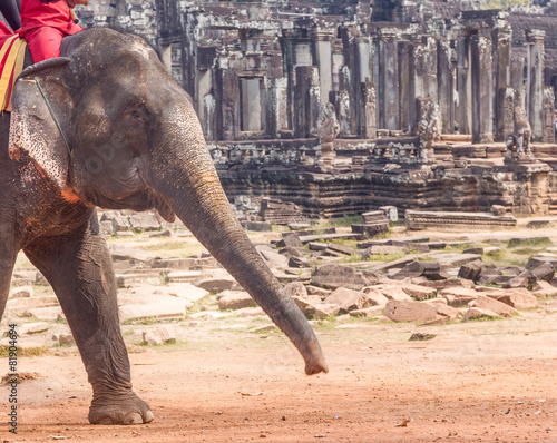 elephant ride on angkor background, bayon temple view photo