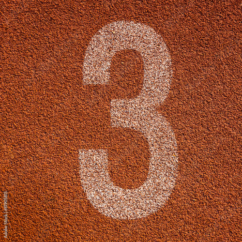 White track number on red rubber racetrack. textured running rac